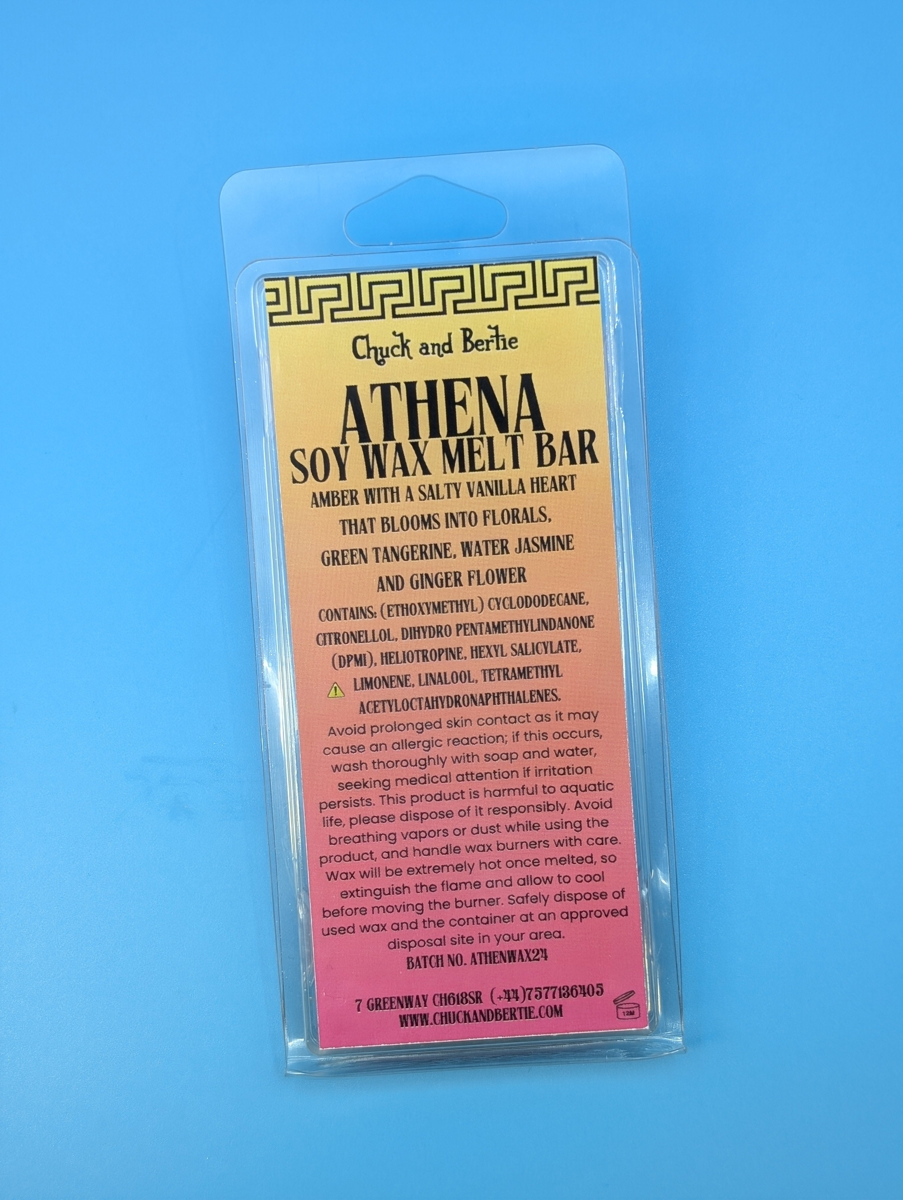 THE ATHENA WAX BAR IN ITS PACKAGING IS POSITIONED ON A BLUE BACKGROUND